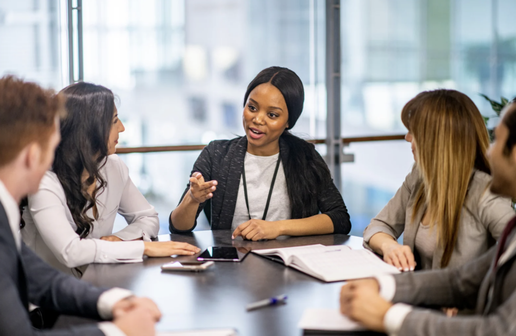 Business Professionals sitting at a table talking
